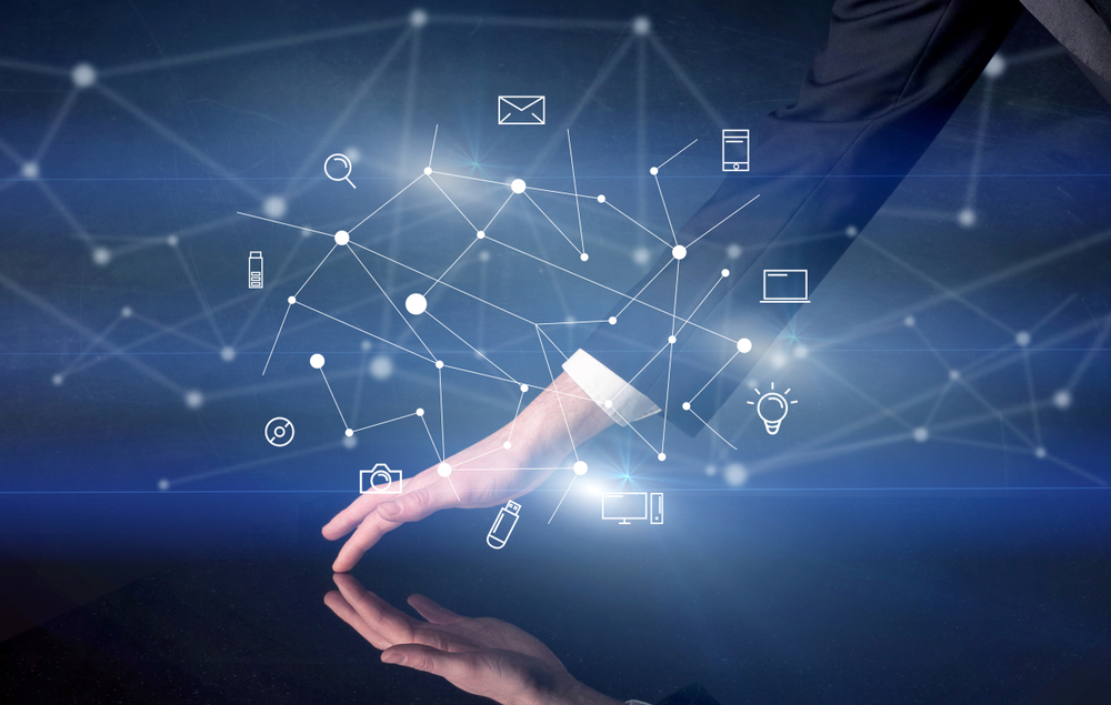 Male hands touching interactive table with blue mixed communication icons in the background